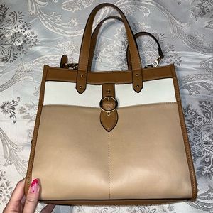 Tan Tote Bag. Measures 12” wide x 11” tall strap measurements are 21” long.